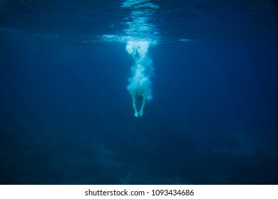 partial view of man diving into ocean