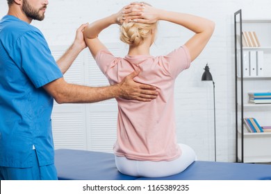 Partial View Of Physiotherapist Doing Massage To Woman On Massage Table In Hospital