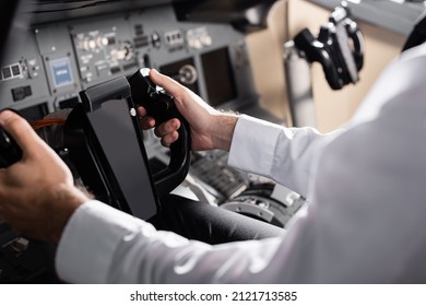 Partial View Of Pilot Using Yoke In Airplane Simulator