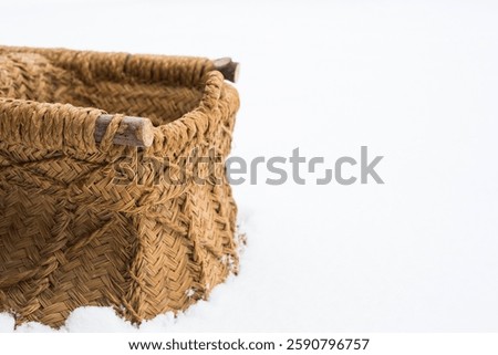 Partial View of a Rustic and Primitive Carrying Basket Sitting in Fresh Snow in Winter