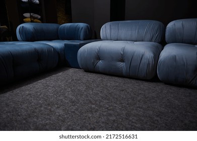 Partial View Of A Stylish Modern Blue Satin Couch Displayed For Sale In A Furniture Design Store. Home Interior Design Concept