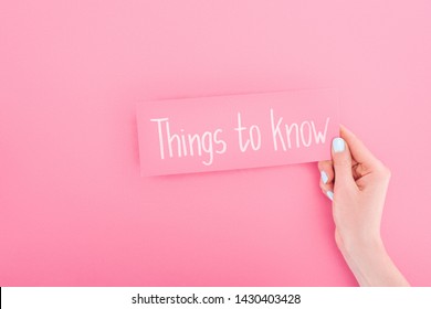 Partial View Of Woman Holding Card With Things To Know Lettering On Pink Background