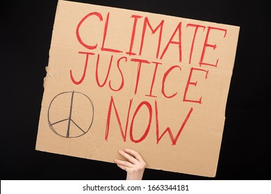 Partial View Of Woman Holding Placard With Climate Justice Now Lettering Isolated On Black, Global Warming Concept