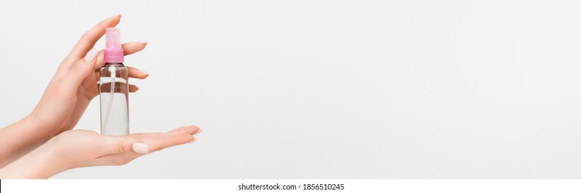 Partial View Of Woman Holding Spray Bottle With Aromatic Mist In Hands Isolated On White, Banner