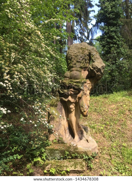 Partially Broken Hidden Sculpture Among Trees Royalty Free Stock