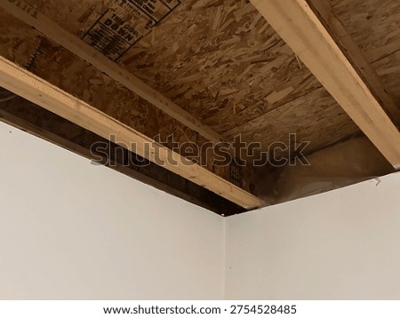 Partially built basement construction space with exposed wood framing concrete floor and unfinished interior structure