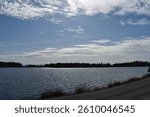 A partially cloudy sky hovering over a shivering lake in Washington