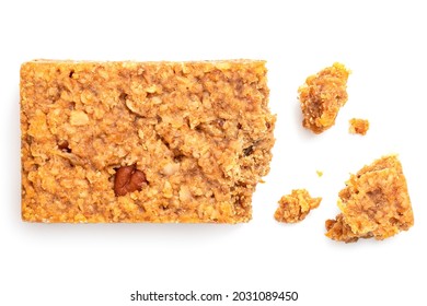 Partially eaten oat flapjack with nuts isolated on white. With crumbs. Top view.
