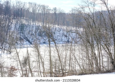 Partially Frozen Water At The Loyalhanna Reservoir Located In Western Pennsylvania. Riverbank, Trees, Ice.