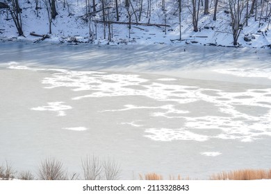 Partially Frozen Water At The Loyalhanna Reservoir Located In Western Pennsylvania. Riverbank, Trees, Ice.