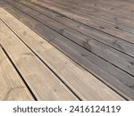 Partially painted and partly cleaned fluted wood terrace impregnated with oil. Decking of wooden planks