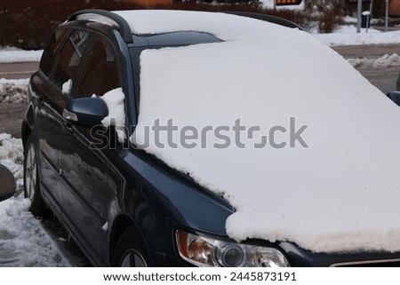A partially snow-covered vehicle parked in Stockholm, Sweden. It is not uncommon for some snow to fall in the beginning of April as on this occasion. GoranOfSweden
