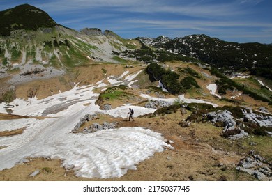 Partially snowed landscape in Spring with a hiking trail near Loser mountain and with Brauningalm (Brauning Hamlet) in the background, Salzkammergut, Styria, Austria, Europe - Shutterstock ID 2175037745