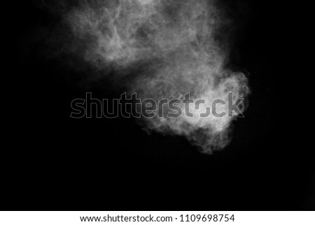 particles of charcoal on black background,abstract powder splatted background.Freeze motion of White powder exploding or throwing White powder.