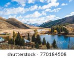 Partly cloudy blue sky over mountain landscape, lake, and countryside properties. Deer Creek in Hailey, Idaho, USA.