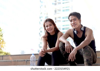 Partner Buddy Runner Man And Woman Lover Sitting Staircase Outdoor, Resting At After Exercise Run Outdoor, Partner Buddy Runner Jogger Athlete Training And Doing Workout In Downtown City.