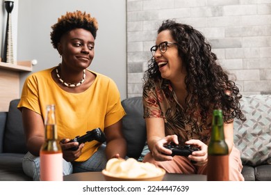 Partner plays with the other and they play video games on the sofa in the living room at home - Powered by Shutterstock