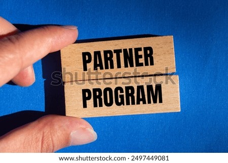 Partner program message written on wooden blocks on blue background. Conceptual partner program symbol. Copy space.