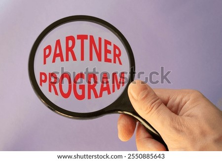 Partner Program symbol. Concept words Partner Program on magnifying glass. Businessman hand. Beautiful purple background. Business and Partner Program concept. Copy space.