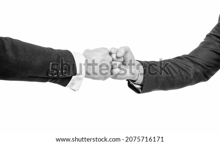 partner relationship. male friendship. businessmeeting. two pumping fist. business deal.
