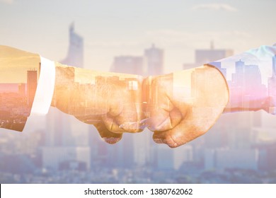 Partners fistbump with multiple exposure. Global business concept