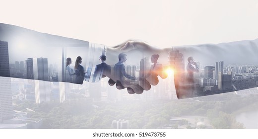 Partners shaking hands . Mixed media - Shutterstock ID 519473755
