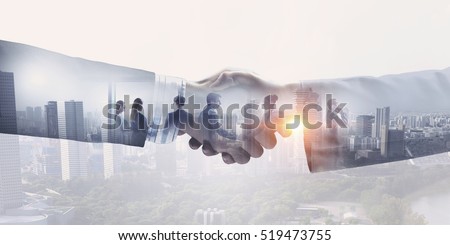 Partners shaking hands . Mixed media