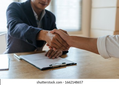 Partnership. business people shaking hand after business signing contract and resume on desk in meeting room at company office, job interview, investor, negotiation, partnership and teamwork concept