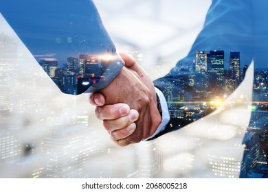 Partnership. multi exposure of investor businessman handshake with partner for successful meeting with night city background, digital technology, investment, negotiation, partnership, teamwork concept