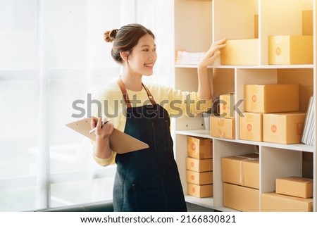 Partnership of SME entrepreneur teamwork of small business work at home family online marketing with packing box prepare for deliverty to customers at warehouse home seller office.