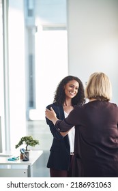 Partnership, Teamwork And Support With A Handshake Between Two Professional Business Women Meeting And Greeting In An Office. Success Discussion With HR About A Promotion Or Positive Feedback
