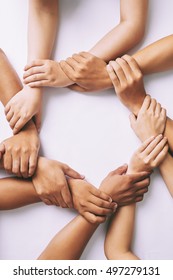 Partnership and unity concept: people holding wrists of each other