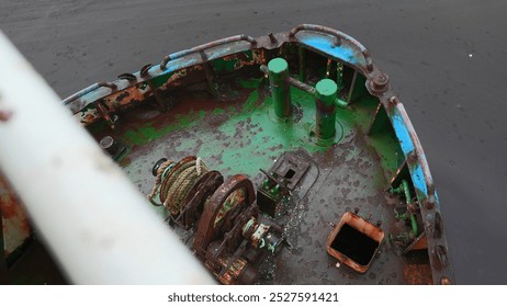 Parts of abandoned fishing boat. Clip. Abandoned boat with rusty parts on cloudy day. Abandoned fishing boat on seashore - Powered by Shutterstock