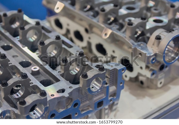 Parts of\
the automobile engine on a table.\
Industry
