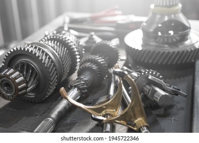 parts of an automotive manual transmission on a table in a car service. Close up