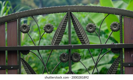 Parts Of Decorative Rod Iron Gate With Nature Background.