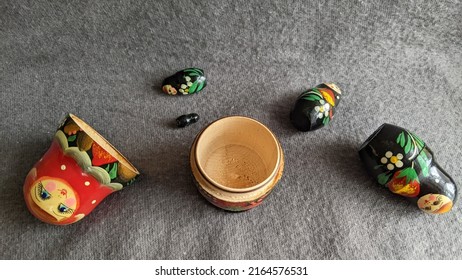 Parts Of A Matryoshka Doll On A Gray Background Lie Side By Side.The Idea Of Aggressive, Deceptive And Empty Russian Culture.