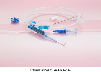 Parts of pressure injectable multi-lumen Peripherally Inserted Central Catheter kit with Vascular Access Guidewire, injection caps, filter needle and introducer needle on rose background 