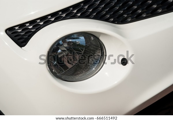 Parts and a white car\
light closeup 