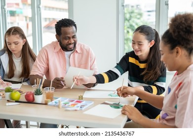 Part-time art teacher with children drawing, practicing drawing and painting. Special classroom. Concept Home school, teaching modifications for children. - Powered by Shutterstock