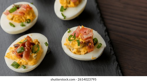  party appetizer featuring deviled eggs topped with crispy bacon and chopped green onions