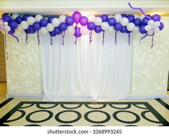 Party backdrop with balloon decorating.
