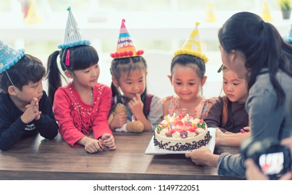 Party Birthday Kid Asian With Cake In Room. Group Of Children Happy Surprise. 