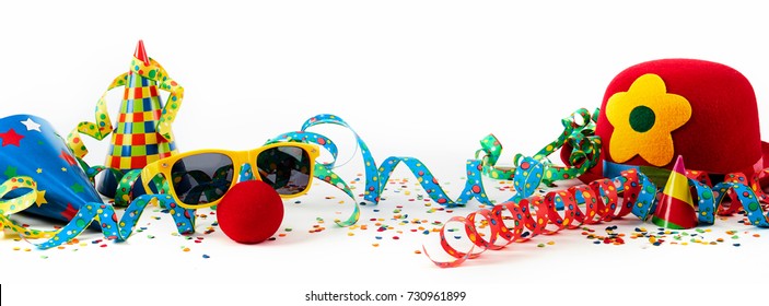 Party or carnival banner with fancy dress accessories and colorful decorations with hats, streamers and confetti in a colorful still life on white
