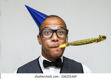 Party celebration with this young geek with a hat and party blower. Christmas, office or birthday concept - Powered by Shutterstock