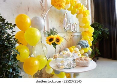 Party decorated with balloons. Photozone from yellow and green balloons. Birthday celebrations, wedding, engagement, baby shower.