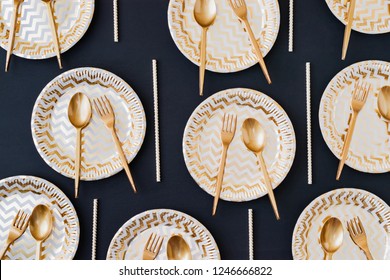 Party Decoration Background. Golden Disposable Dishes On Dark Wooden Background