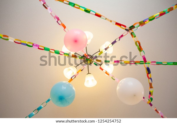 Party Decorations Above Colorful Paper Chains Stock Photo