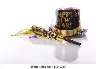 Party favors including top hat that says Happy New Year  and horn isolated against white background