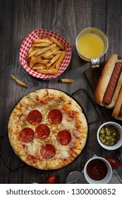 Party Game Day Food Homemade Pizza Hot Dogs Fries Juice And Dips - Super Bowl Food Concept Overhead View